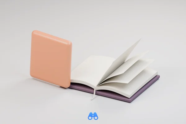 An apricot, rounded-square ceramic tile stands beside an open catalogue with blank ivory pages, a dark plum cover and a slim ribbon bookmark. Several leaves rise from the binding. A small blue MacDigest binocular symbol sits below.